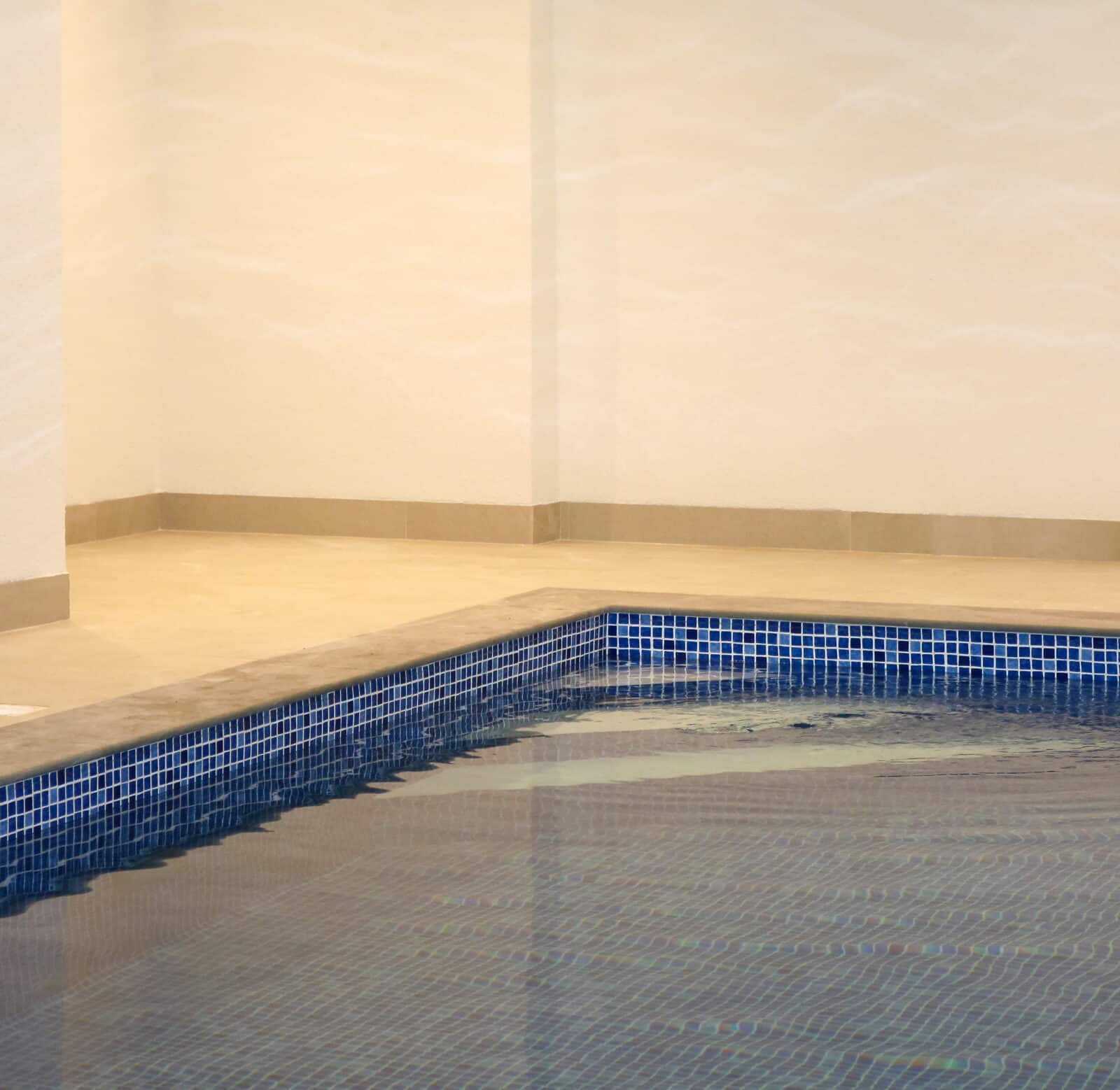 A swimming pool with new rendered walls
