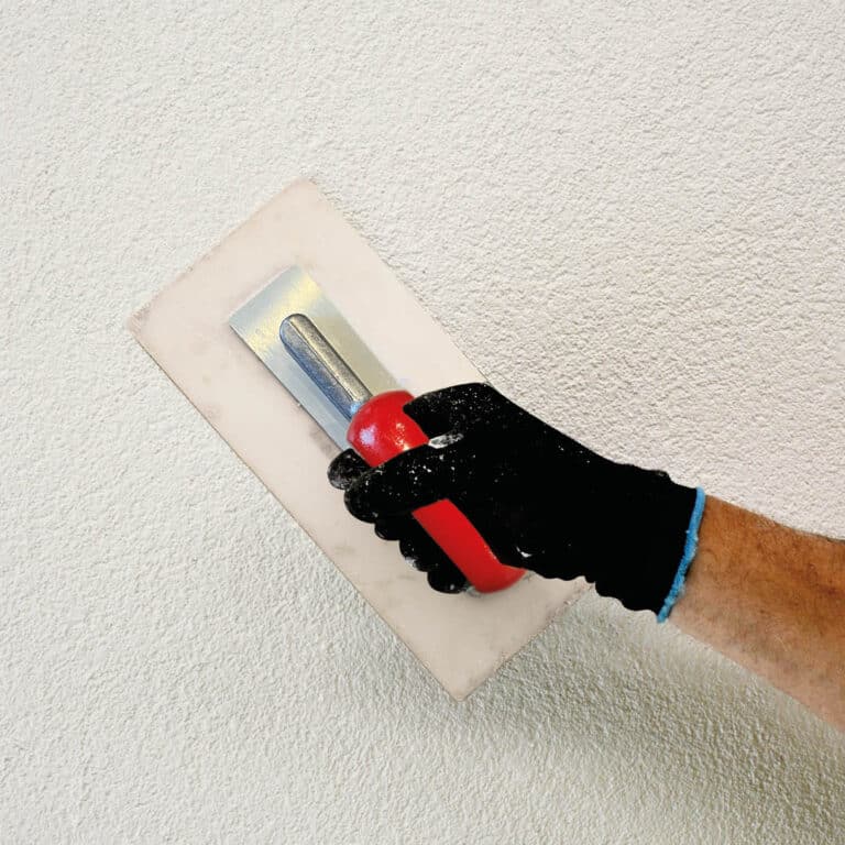 Trowel applying render by hand
