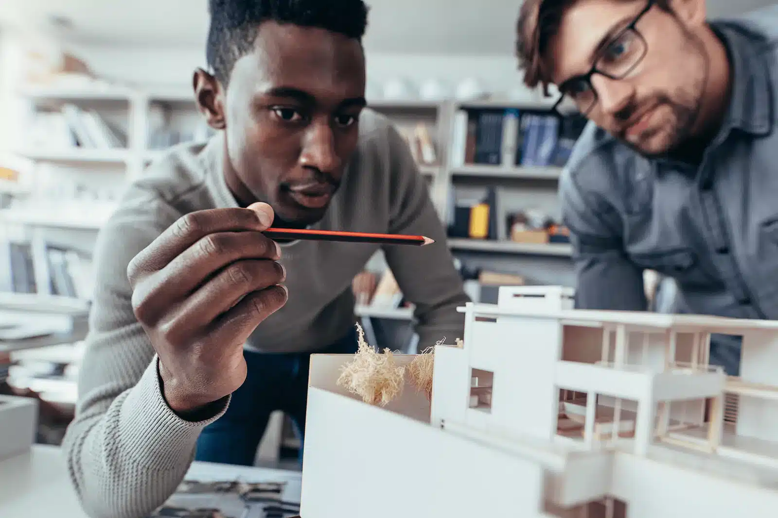 Architects discussing a model design.