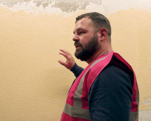 Kirk Johnstone examining a rendered wall