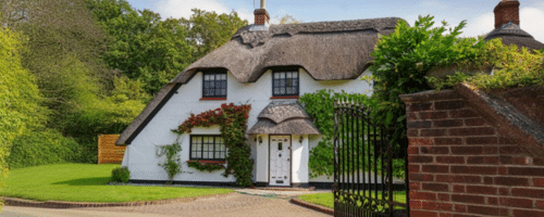 A traditional heritage cottage featuring white lime render
