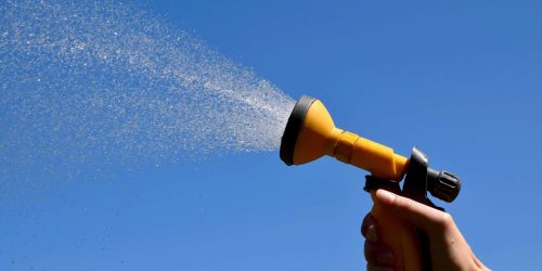 Using water spray to clean house render