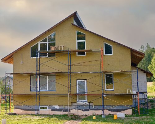 house with external wall insulation being applied