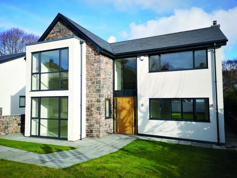 A modern house with external wall insulation featuring render and brick slips