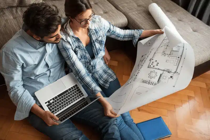 Couple reviewing architectural plans together.