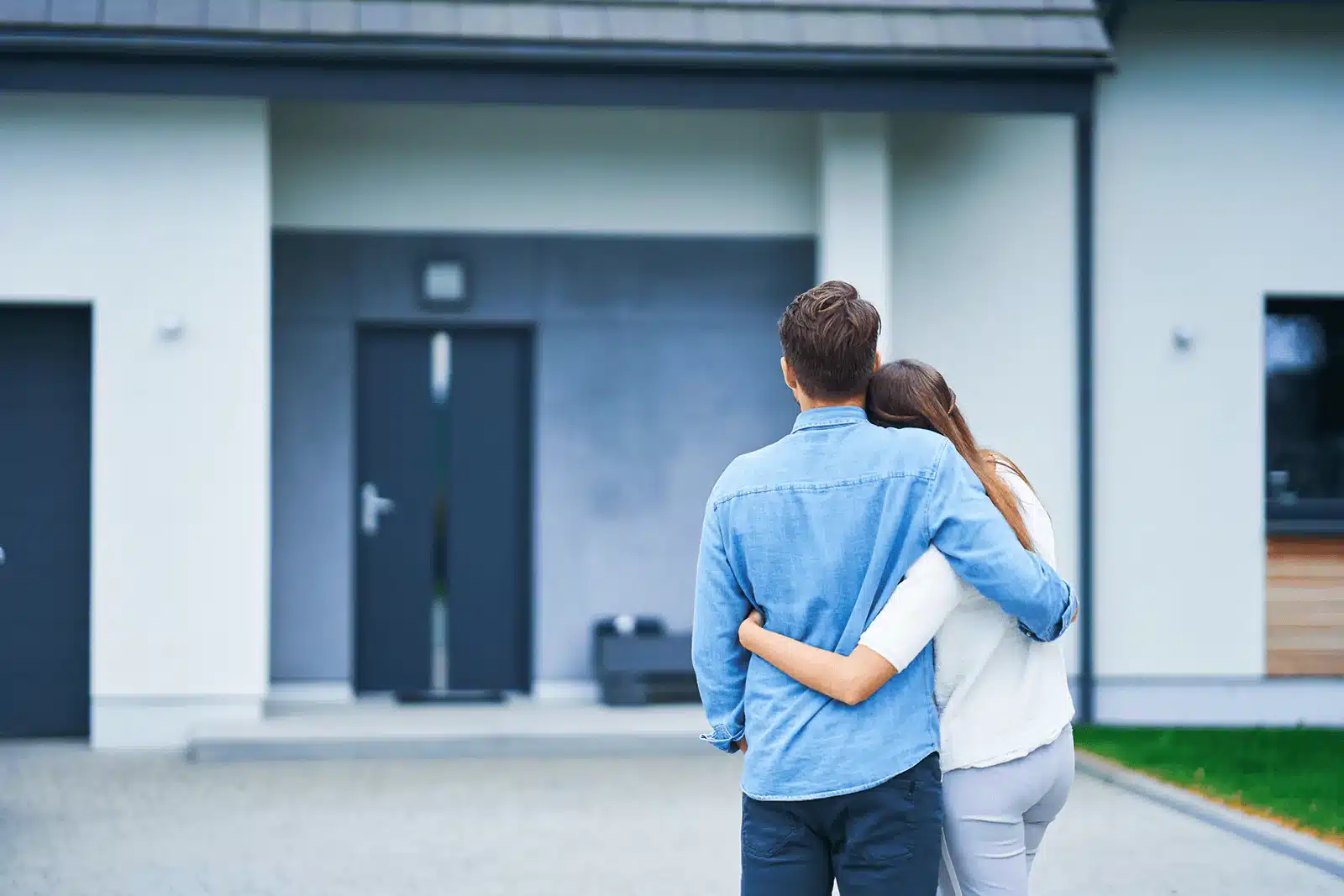 Couple admiring their new home.